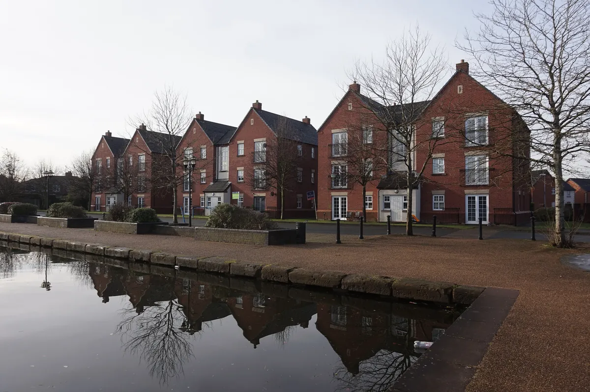 Modern red-brick townhouses and flats beside the Bridgewater Canal at Stretford Marina