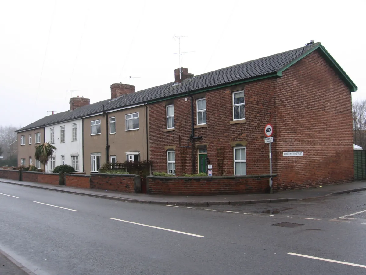 A row of brick terraced houses with low front walls on Gaffers Row in Clay Cross