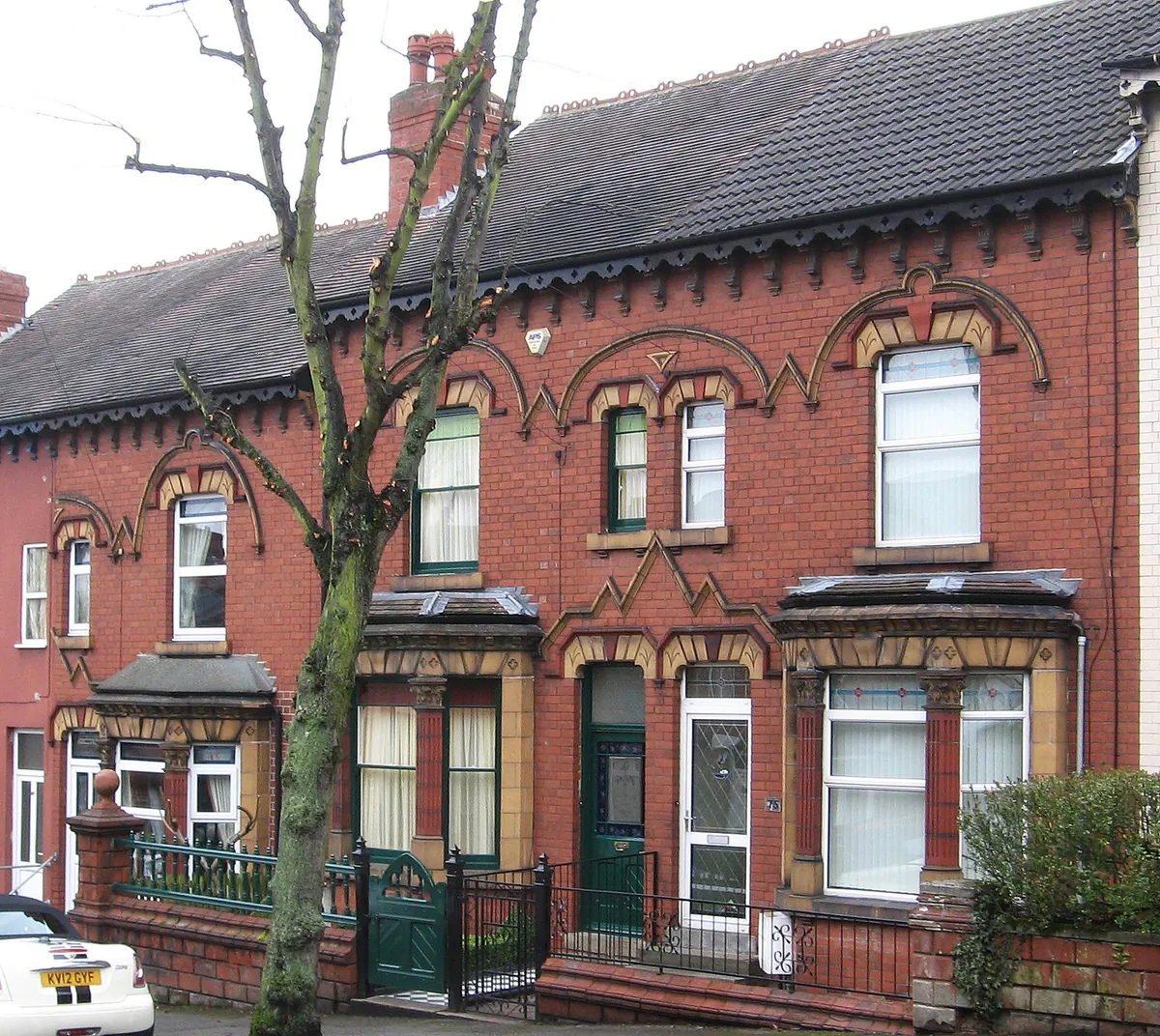 Victorian red-brick terraced houses with patterned brickwork, bay windows and iron railings on Lord Haddon Road in Ilkeston